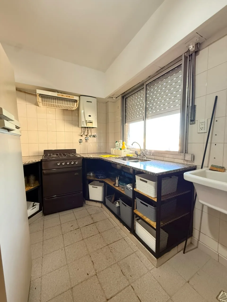 Cocina con ventana, mesada de granito y pileta de lavar